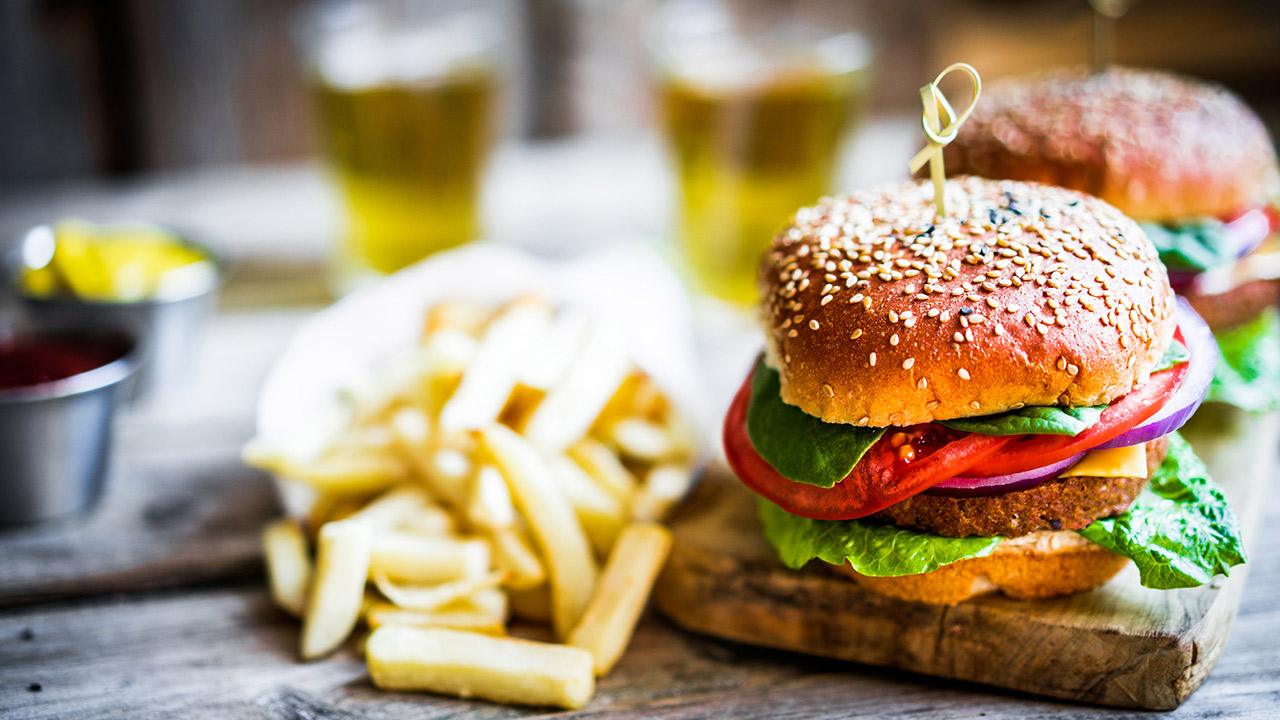 Homemade burgers on rustic wooden background